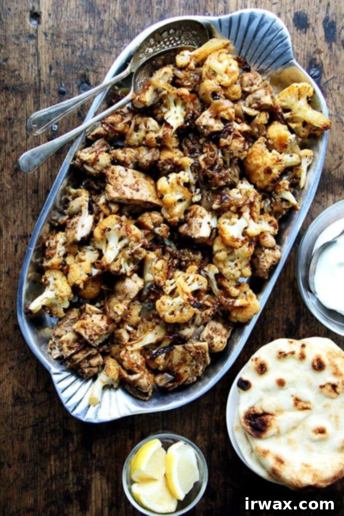 Heres the gist of this sheet pan chicken and cauliflower "shawarma": cauliflower florets, a sliced onion, and a few unpeeled garlic cloves dressed with olive oil and a few thyme sprigs roast for 40 minutes on a sheet pan, where they caramelize before they meet a showering of salty, grated parmesan. The combination of sweet and salty, as you can imagine, is incredibly delicious. // alexandracooks.com Πιατέλα με κοτόπουλο και κουνουπίδι σαουάρμα σε ταψί.
