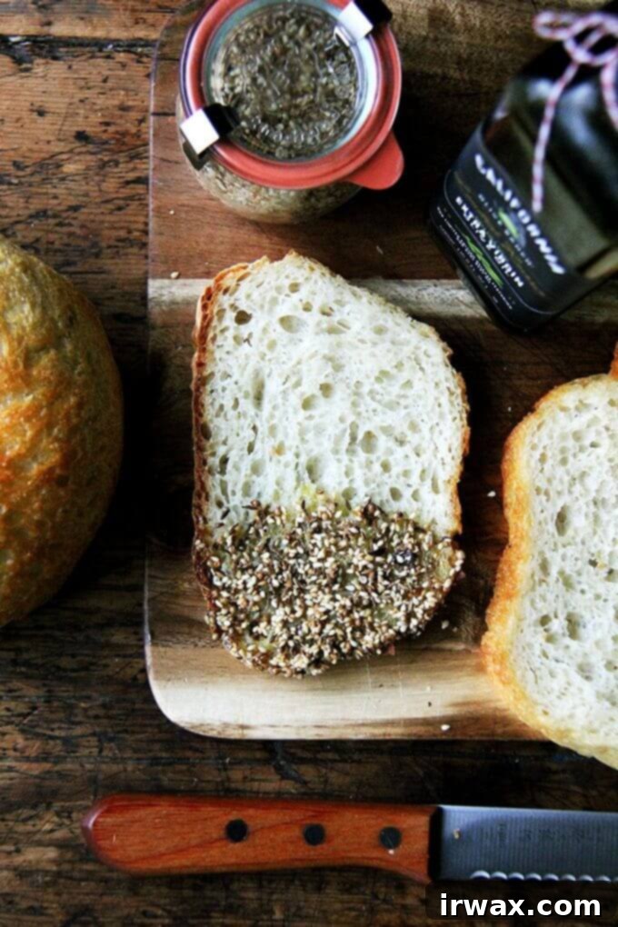 Fresh bread, good olive oil, a smoky, seedy dukkah—this appetizer reminded me how a simple flourish can make such an impression—it can be, in fact, all everyone needs to kick off an evening; it can be everything everyone dreams about for days. // alexandracooks.com Ένα ξύλο κοπής με κομμένο ψωμί βουτηγμένο σε ελαιόλαδο και ντούκα.