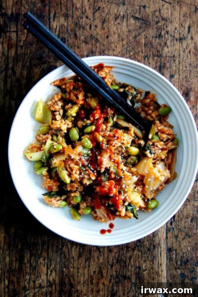 Βίγκαν Κίμτσι Τηγανητό Ρύζι 14 Ένα μπολ με kimchi fried rice γαρνιρισμένο με sriracha.