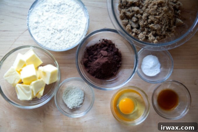 Μαστιχωτά Σοκολατένια Μπισκότα 3 Ingredients to make chocolate sugar cookies on a work surface.