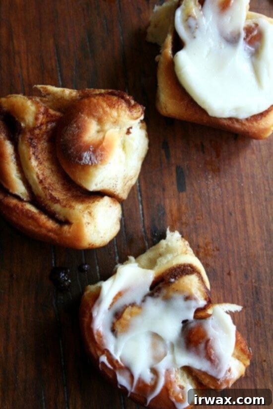 Iced or not, these cinnamon rolls go down fast. Best of all, they can be prepared in advance and baked in the morning. If you don't have a go-to cinnamon roll recipe, look no further. These are amazing! // alexandracooks.com Overhead shot of cinnamon rolls on a table.