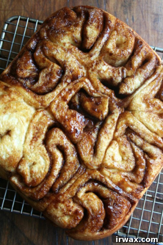 Iced or not, these cinnamon rolls go down fast. Best of all, they can be prepared in advance and baked in the morning. If you don't have a go-to cinnamon roll recipe, look no further. These are amazing! // alexandracooks.com A pan of cinnamon rolls turned out onto a cooling rack.
